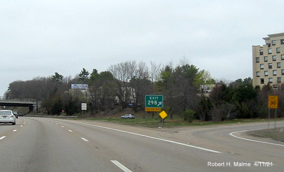 Image of gore sign for US 1 South exit with new milepost based exit number and yellow Old Exit 15 B sign attached below on I-95/MA 128 North in Dedham, April 2021