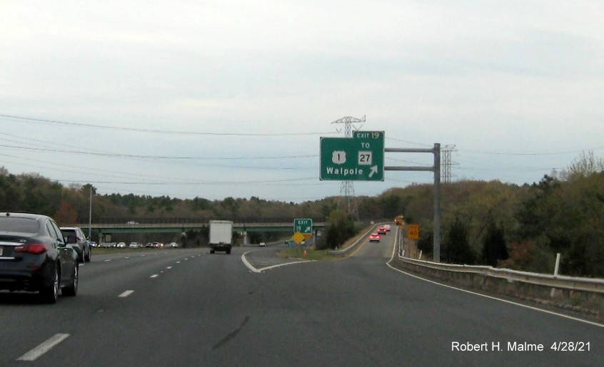 Image of overhead ramp sign for US 1 to MA 27 exit with new milepost based exit number and yellow Old Exit 9 advisory sign on support on I-95 North in Walpole, April 2021