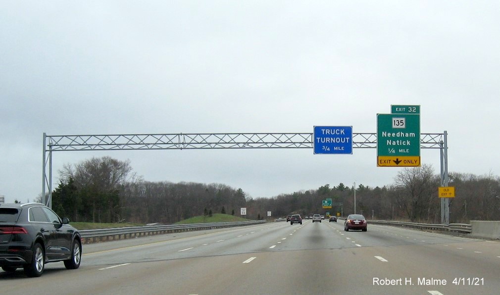 Image of 1/4 Mile advance overhead sign for MA 135 exit with new milepost based exit number and yellow 
                                           Old Exit 17 advisory sign on support on I-95/MA 128 South in Dedham, April 2021
