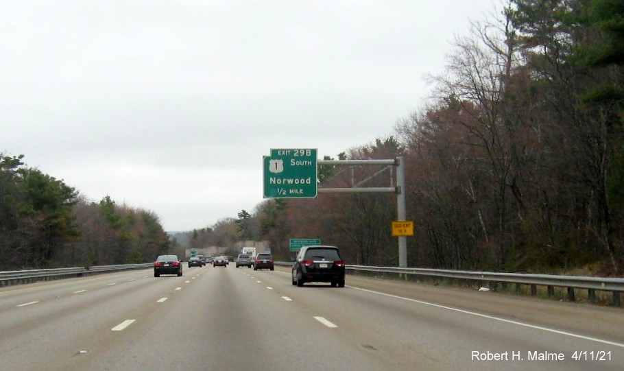 Image of 1/2 Mile advance overhead sign for US 1 South exit with new milepost based exit number and yellow Old Exit 15B advisory sign on support on I-95/MA 128 South in Dedham, April 2021