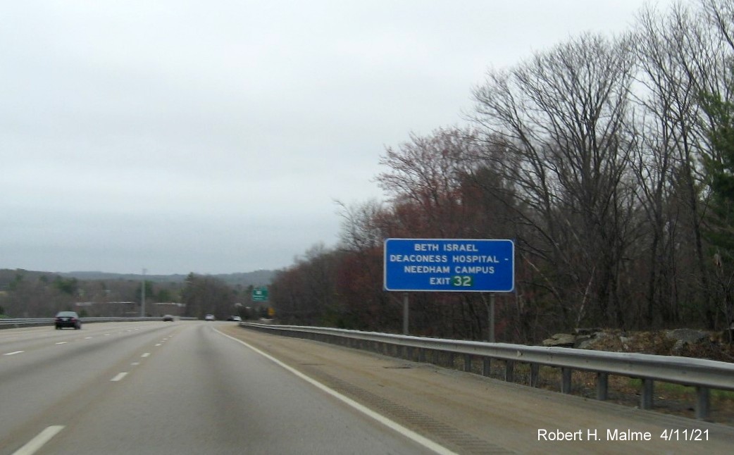 Image of auxiliary blue hospital sign for MA 135 exit with new milepost based exit number in green 
                                           on I-95/MA 128 North in Dedham, April 2021