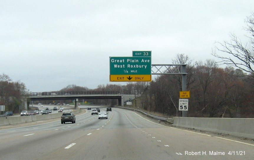 Image of 1/4 mile advance overhead sign for Great Plain Avenue exit with new milepost based exit number and yellow Old Exit 18 advisory sign on support on I-95/MA
                                           128 North in Dedham, April 2021