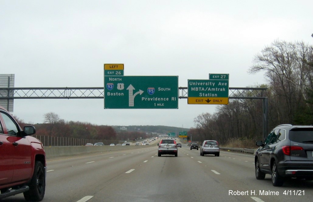 Image of 1 Mile advance overhead diagrammatic sign for North I-93/US 1 exit with new milepost based exit number and yellow Old Exit 12 advisory sign on right support on I-95/MA 128 South, US 1 North in Westwood, April 2021 