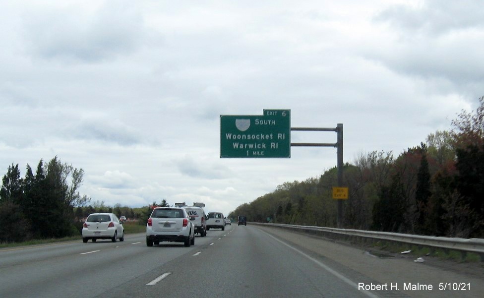 Image of 1 mile advance overhead sign for I-295 South exit with new milepost based exit number and yellow Old Exit 4 sign on support on I-95 north in Attleboro, May 2021