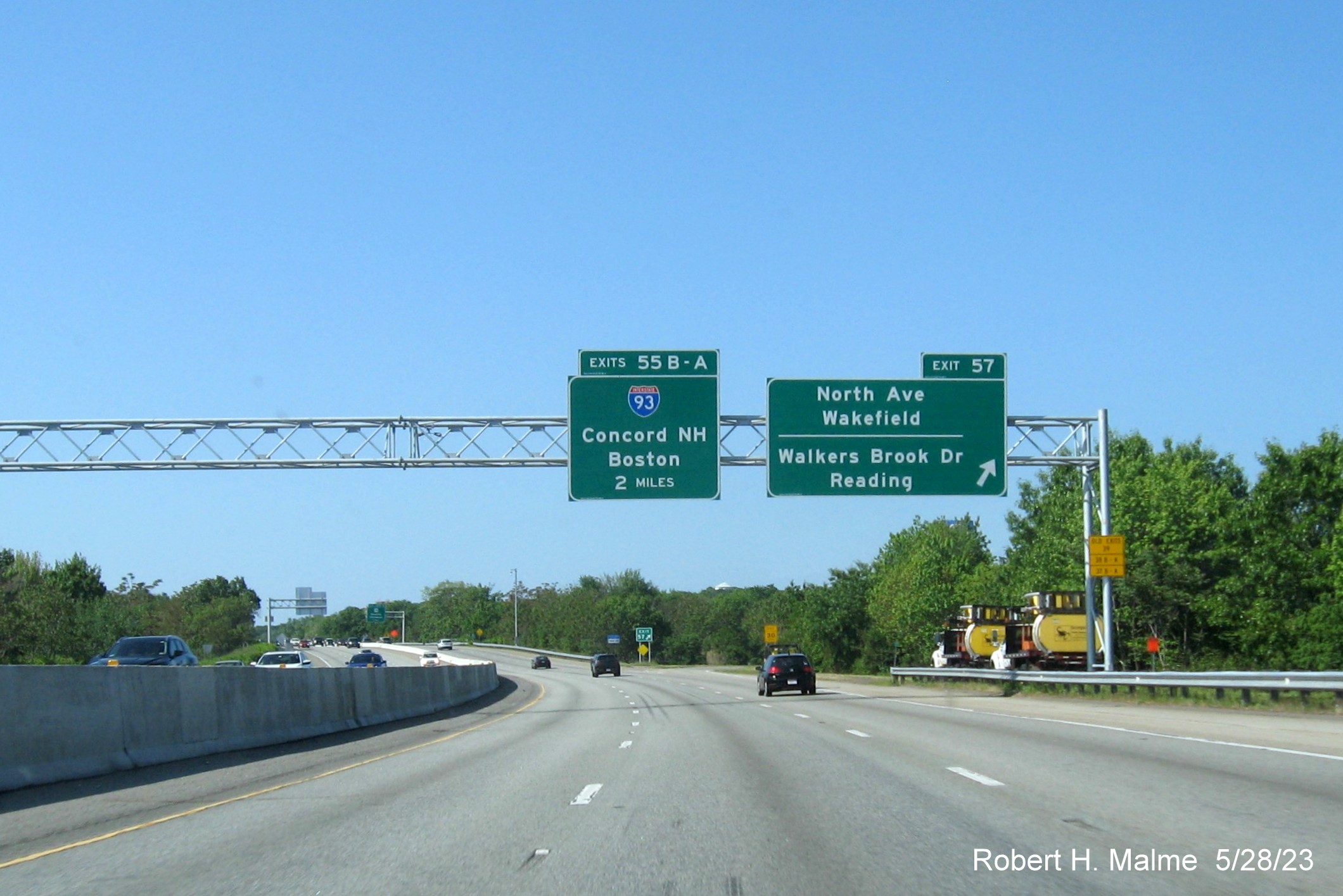 Image of recently placed 2 Mile advance overhead sign for the I-93 North exit with exit sign for the North 
        Avenue/Walkers Brook Drive exit on I-95/MA 128 South in Wakefield, May 2023
