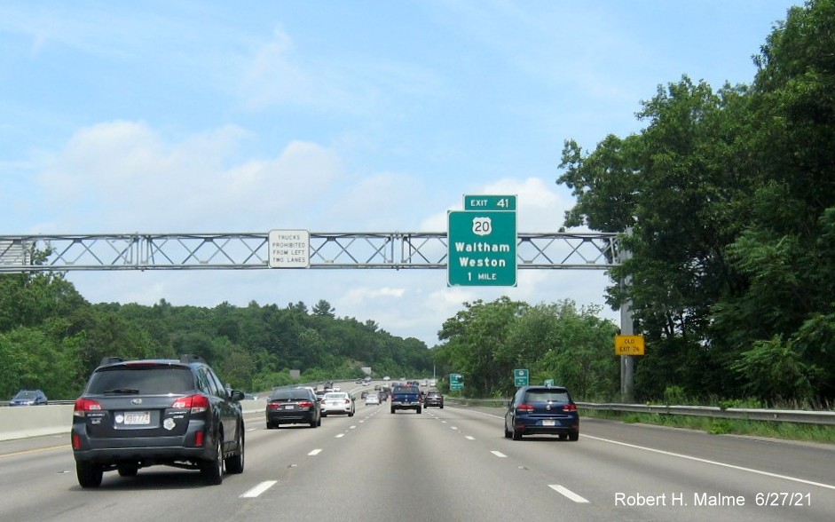 Image of 1 Mile advance overhead sign for US 20 exit with new milepost based exit number and yellow Old Exit 26 advisory sign on right support on I-95/MA 128 North in Waltham, June 2021