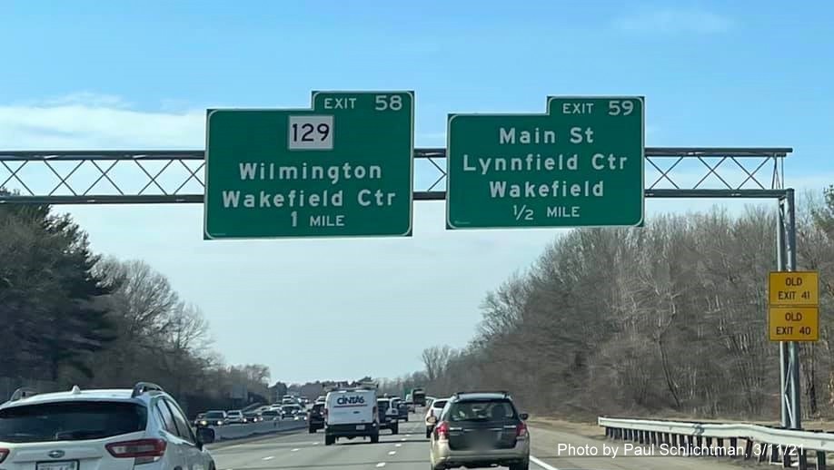 Image of overhead advance signs for MA 129 and Main Street exits with new milepost based exit numbers and yellow Old Exit 41 and 40 signs on right support post on I-95 South in Lynnfield, by Paul Schlichtman, March 2021