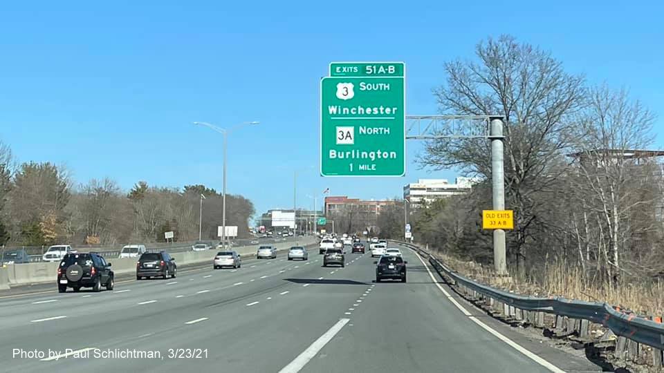 Image of 1 mile advance overhead sign for US 3 South/MA 3A North exits with new milepost based exit numbers and yellow Old Exits 33 A-B advisory sign on support on I-95/MA 128 North in Burlington, by Paul Schlichtman, March 2021