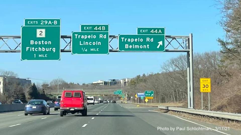 Image of overhead signage at ramp for Trapelo Road Belmont exit with new milepost based exit number on I-95/MA 128 North in Waltham, by Paul Schlichtman, March 2021