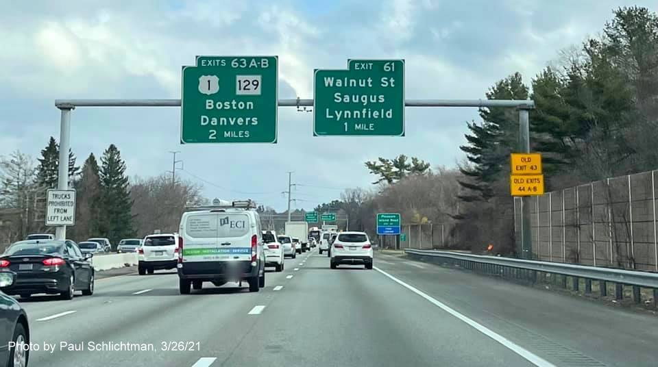 Image of overhead advance signage for US 1/MA 129 and Walnut Street exits with new milepost based exit numbers and yellow Old Exit advisory signs on right support post on I-95/MA 128 North in Lynnfield, by Paul Schlichtman, March 2021