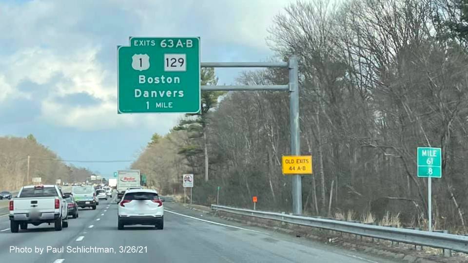 Image of 1 Mile advance overhead sign for US 1/MA 129 exits with new milepost based exit numbers and yellow Old Exits 44 A-B advisory sign on support post on I-95/MA 128 North in Lynnfield, by Paul Schlichtman, March 2021