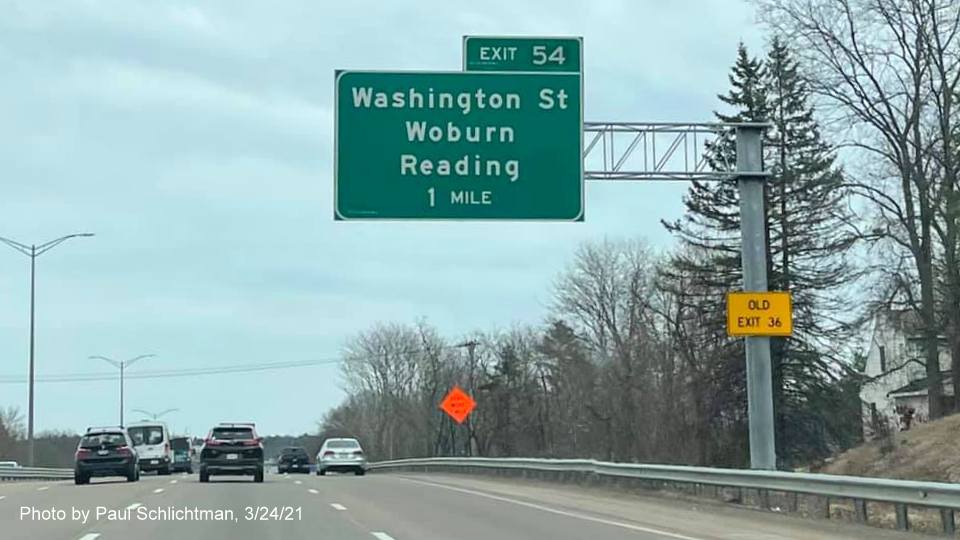 Image of 1 Mile advance overhead sign for Washington Street exit with new milepost based exit number and yellow Old Exit 36 advisory sign on support on I-95/MA 128 North in Woburn, by Paul Schlichtman, March 2021