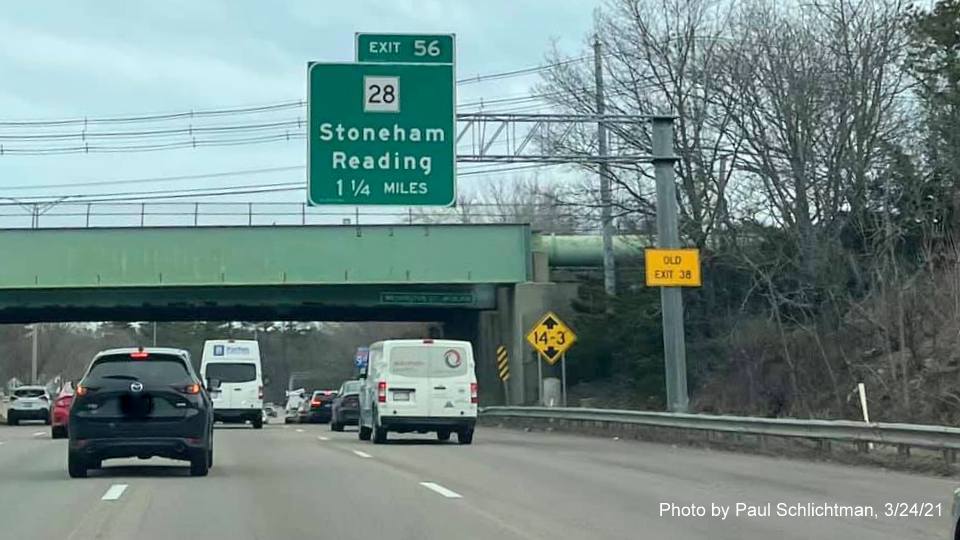 Image of 1 1/4 Miles advance overhead sign for MA 28 exit (with wrong exit number in tab) with new milepost based exit number and yellow Old Exit 38 advisory sign on support on I-95/MA 128 North in Woburn, by Paul Schlichtman, March 2021