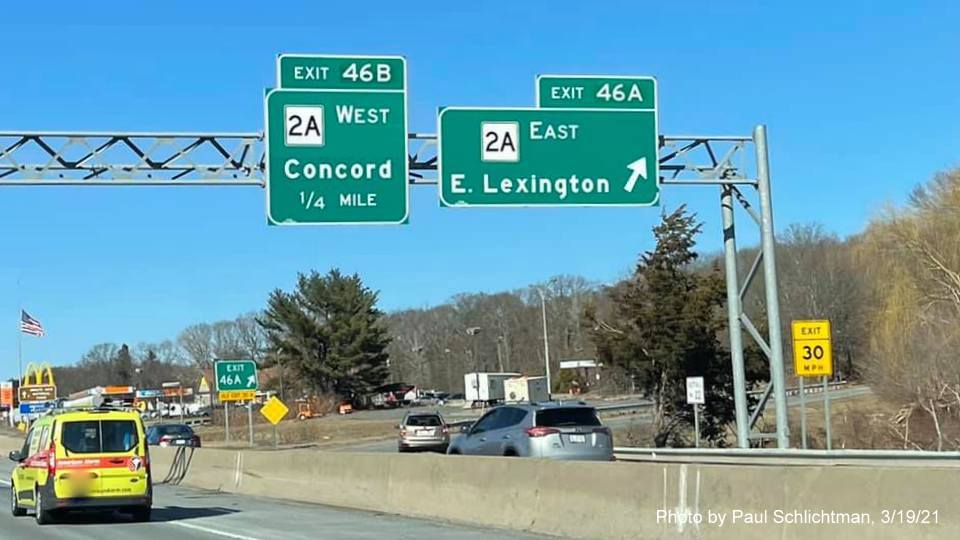 Image of overhead ramp sign for MA 2A East exit with new milepost based exit number on I-95/MA 128 North in Waltham, by Paul Schlichtman, March 2021