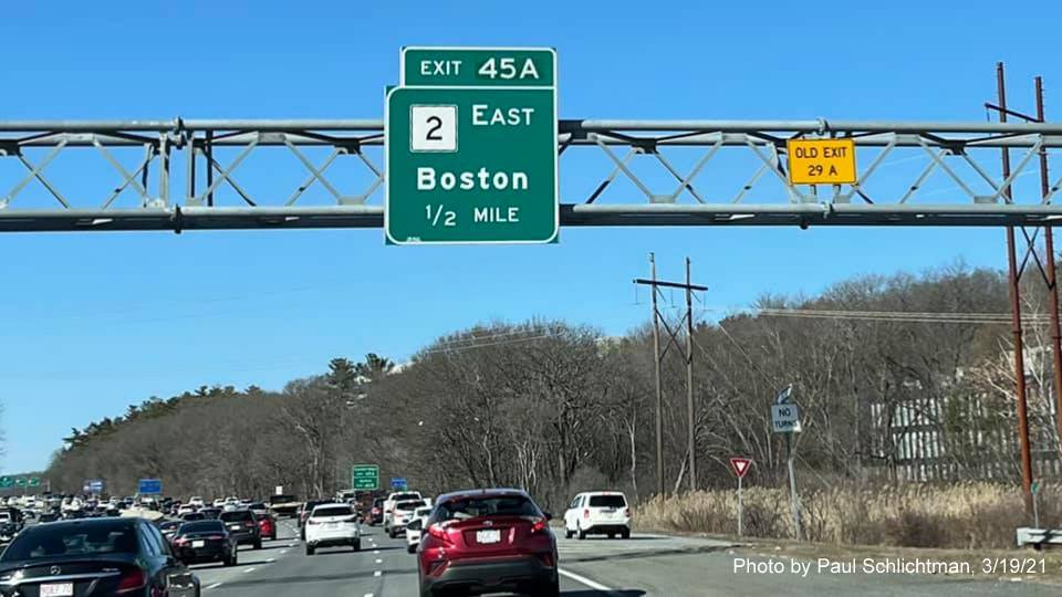 Image of 1/2 Mile advance sign for MA 2 East exit with new milepost based exit number and yellow old Exits 29 A-B sign on gantry on I-95/MA 128 North in Lexington, photo by Paul Schlictman, March 2021