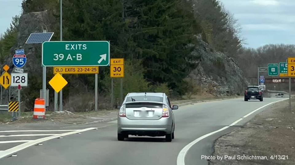 Image of gore sign for I-90/Mass Pike and MA 30 exits with new milepost based exit numbers and yellow Old Exits 23-24-25 sign attached below on I-95/128 North in Newton, by Paul Schlichtman, April 2021