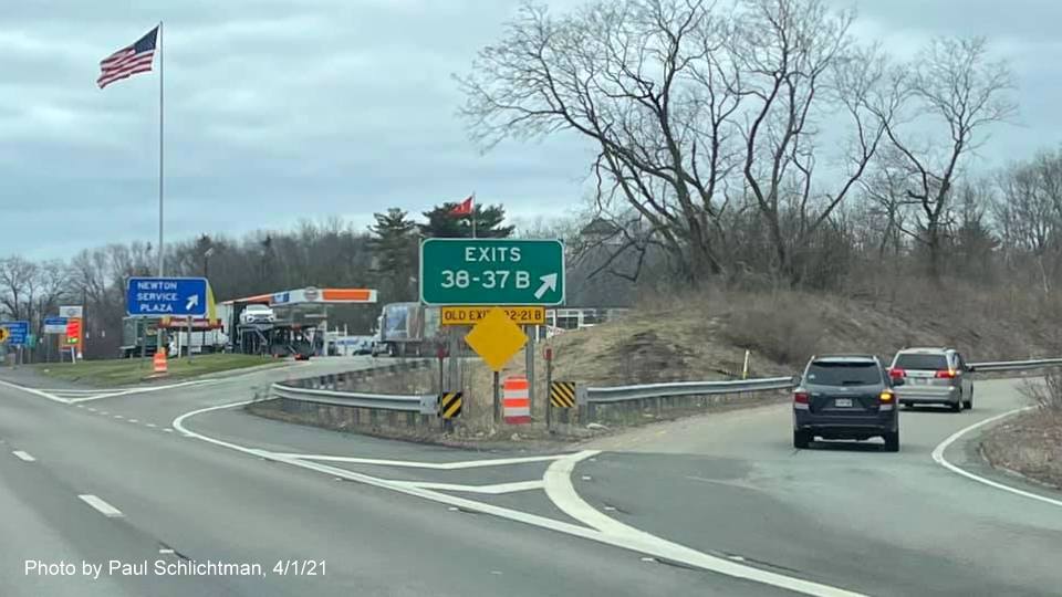 Image of gore sign for Grove Street/ MA 16 West exits with new milepost based exit number and yellow Old Exits 22-21B advisory sign below on I-95/MA 128 South in Newton, by Paul Schlichtman, April 2021