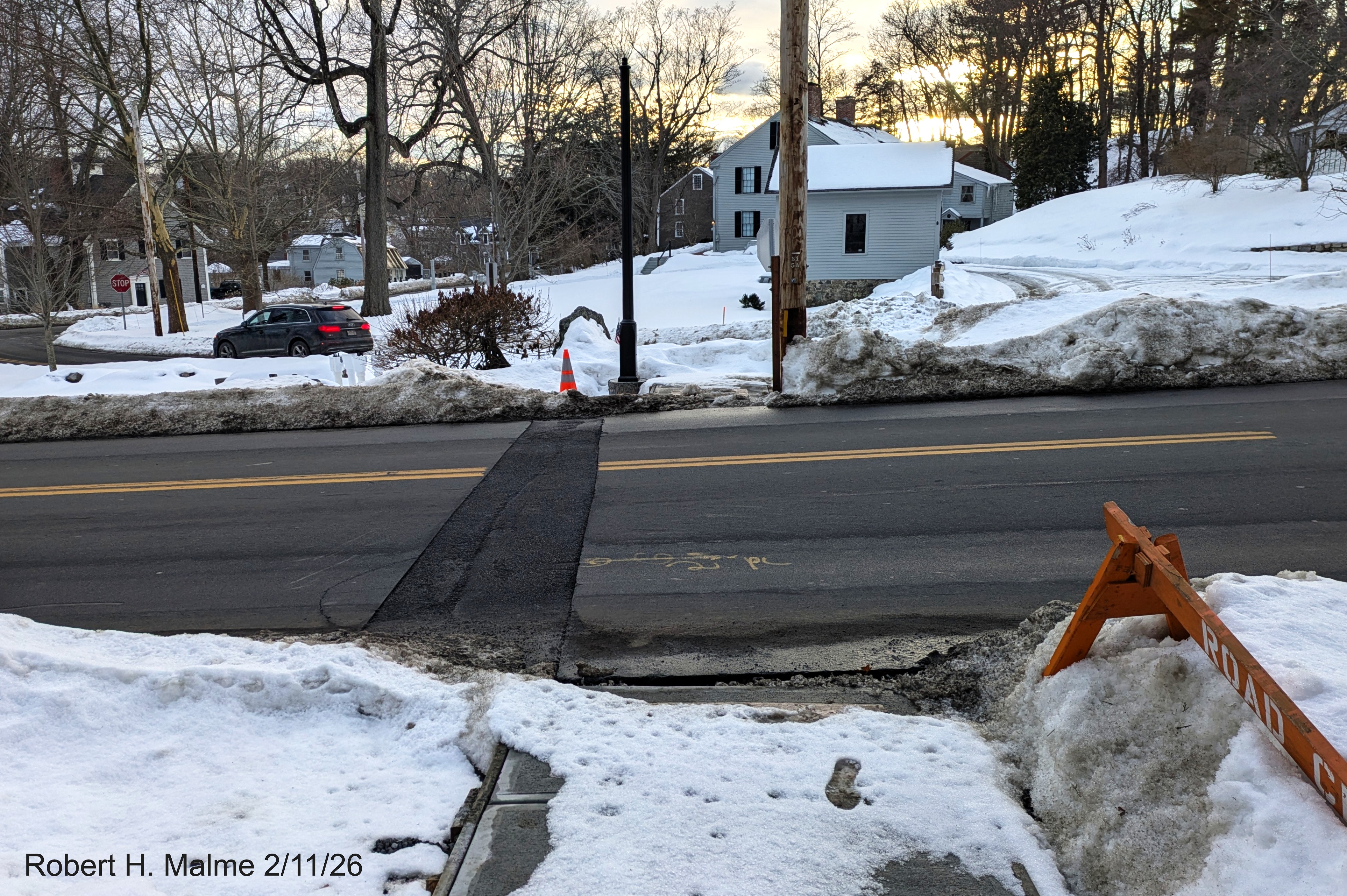 Image of construction of new pedestrian crosswalk with signals on Lincoln Street looking 
	west across the street towards the Benjamin Lincoln House, February 2026