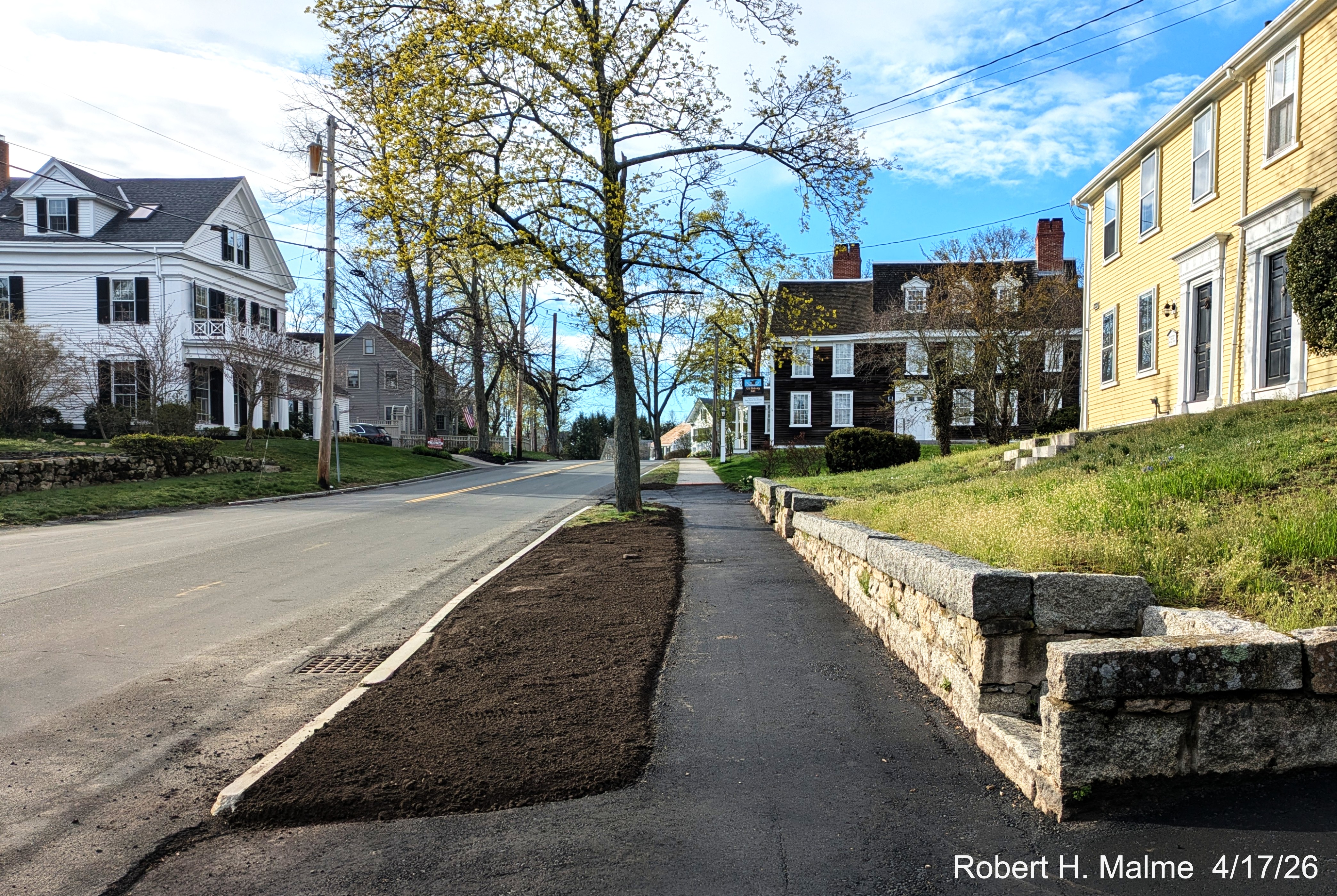 Image looking north along Lincoln Street along newly paved sidewalk towards the Old 
	Ordinary, April 2026