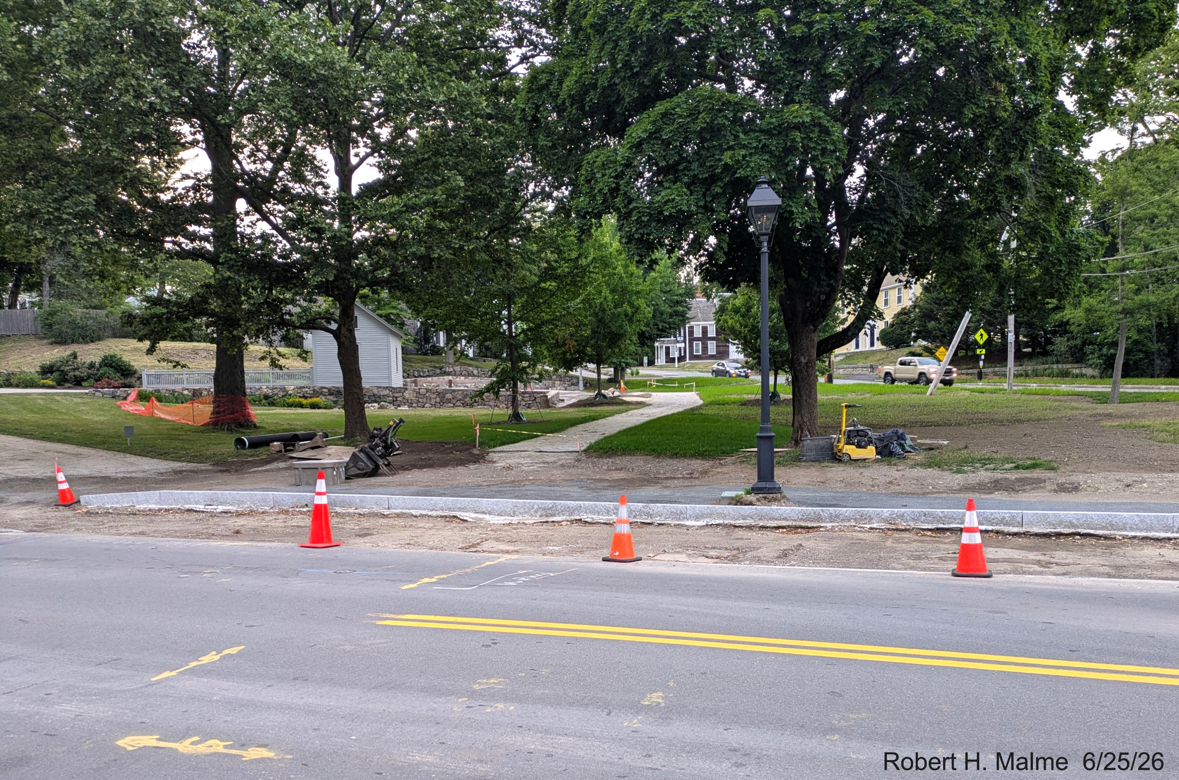 Image taken of completed granite curbing along North Street, with need paving at the
	site of future parking spaces by the Benjamin Lincoln House, June 2026
