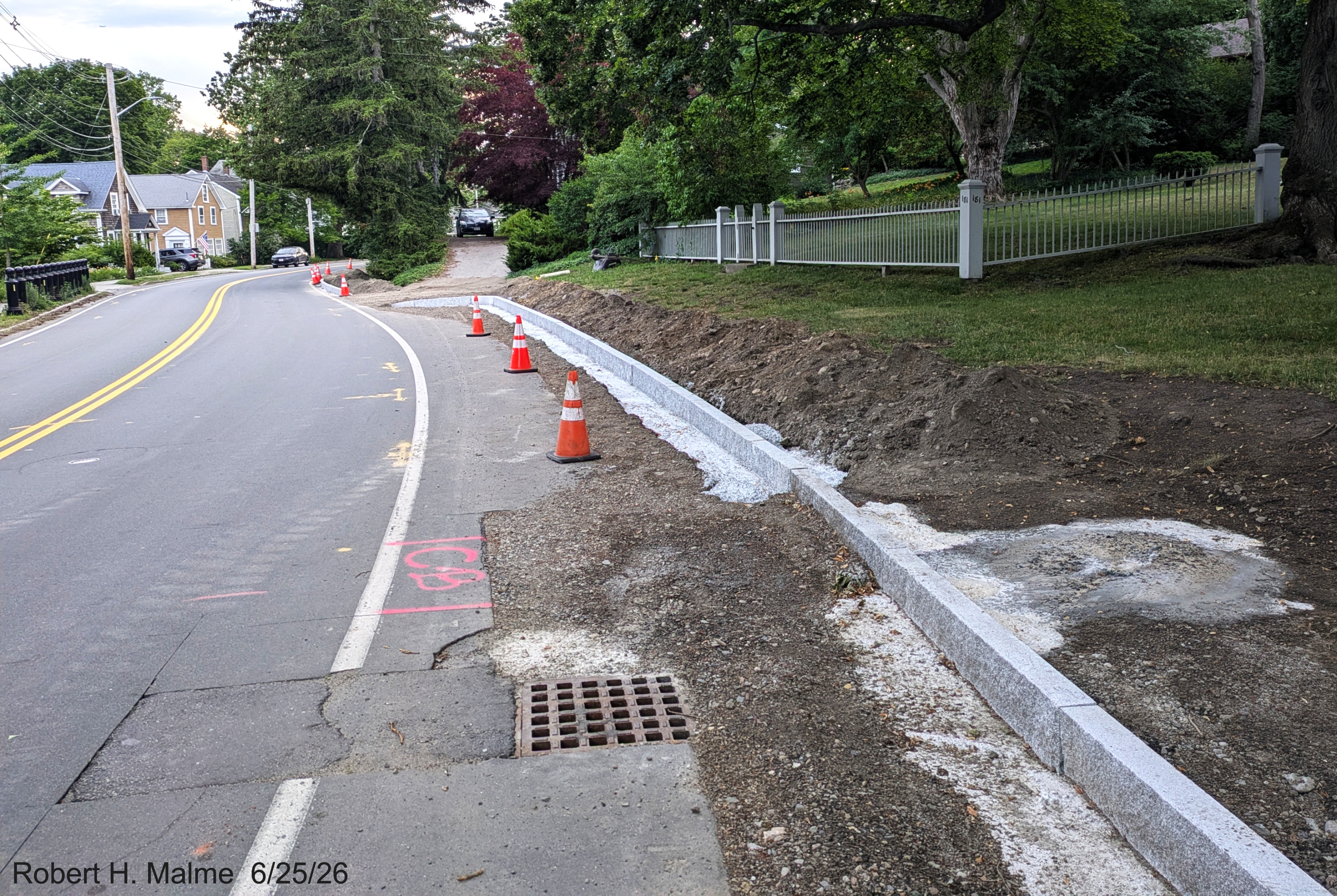 Image taken of granite curbing continuing west along North Street, with a gap
	for other driveways, June 2026