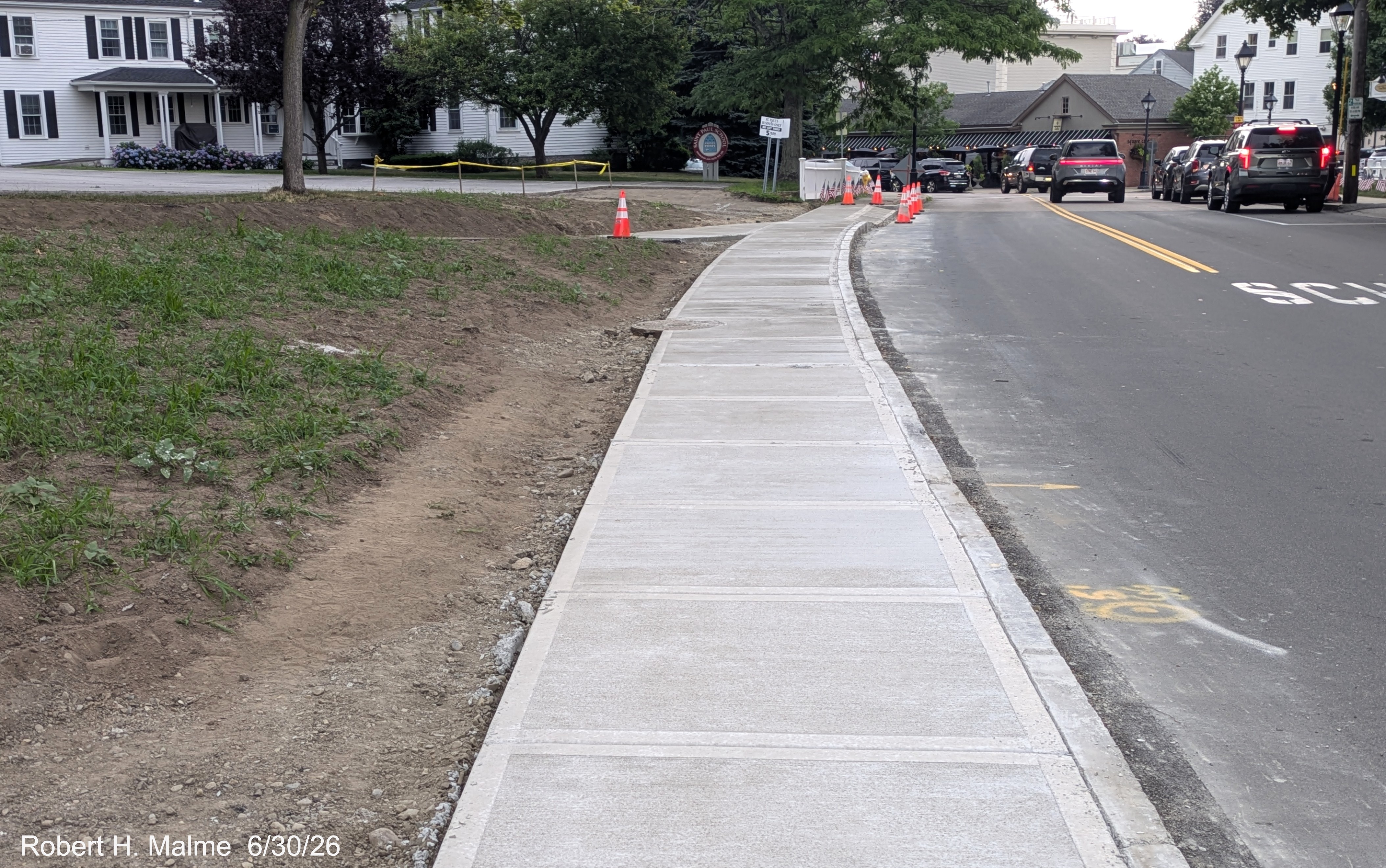Image taken looking along North Street at the newly installed concrete sidewalk along
	the road, June 2026