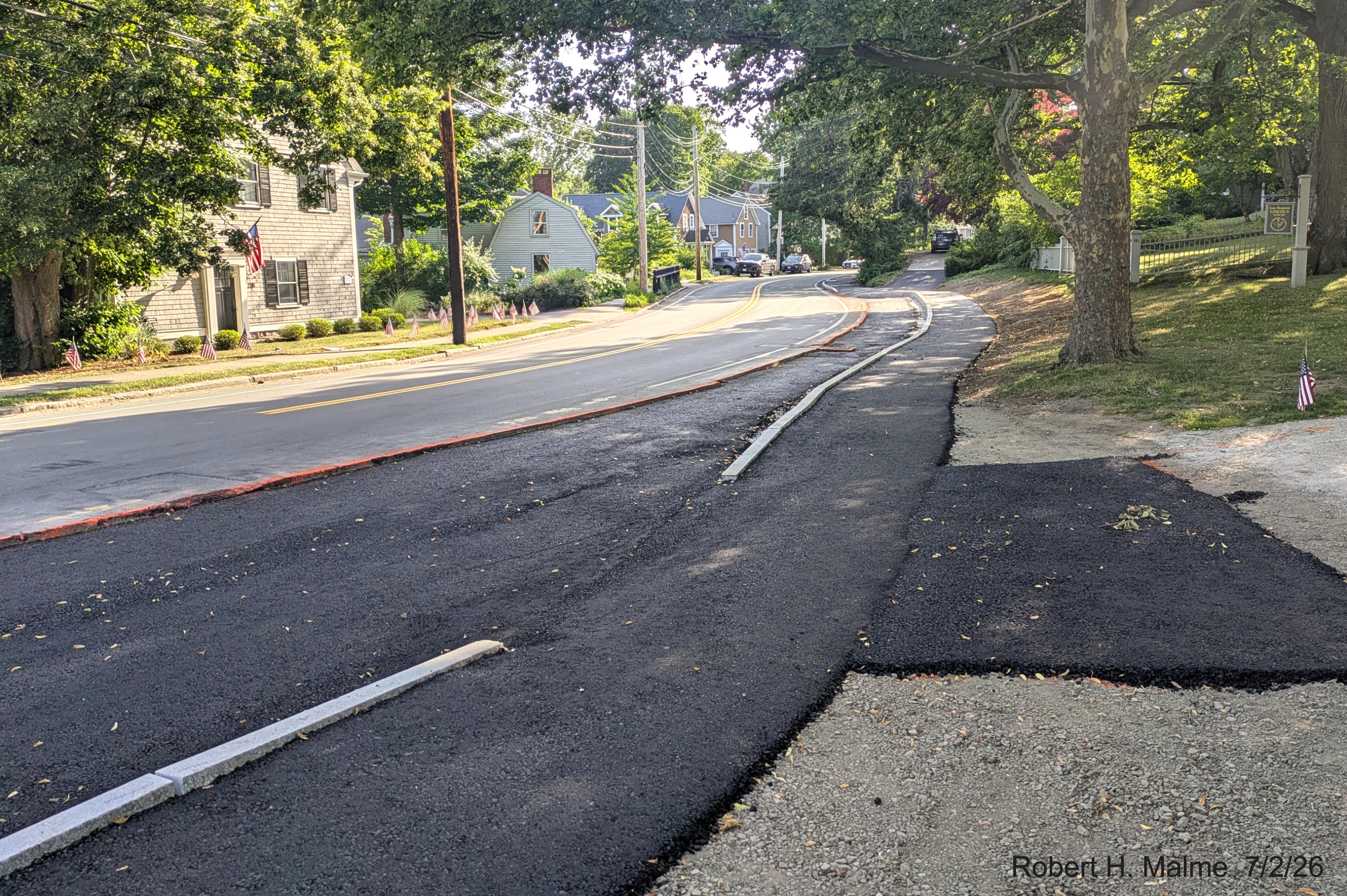 Image taken looking west on North Street showing new paved sidewalk next to the Benjamin 
	Lincoln House property, July 2026