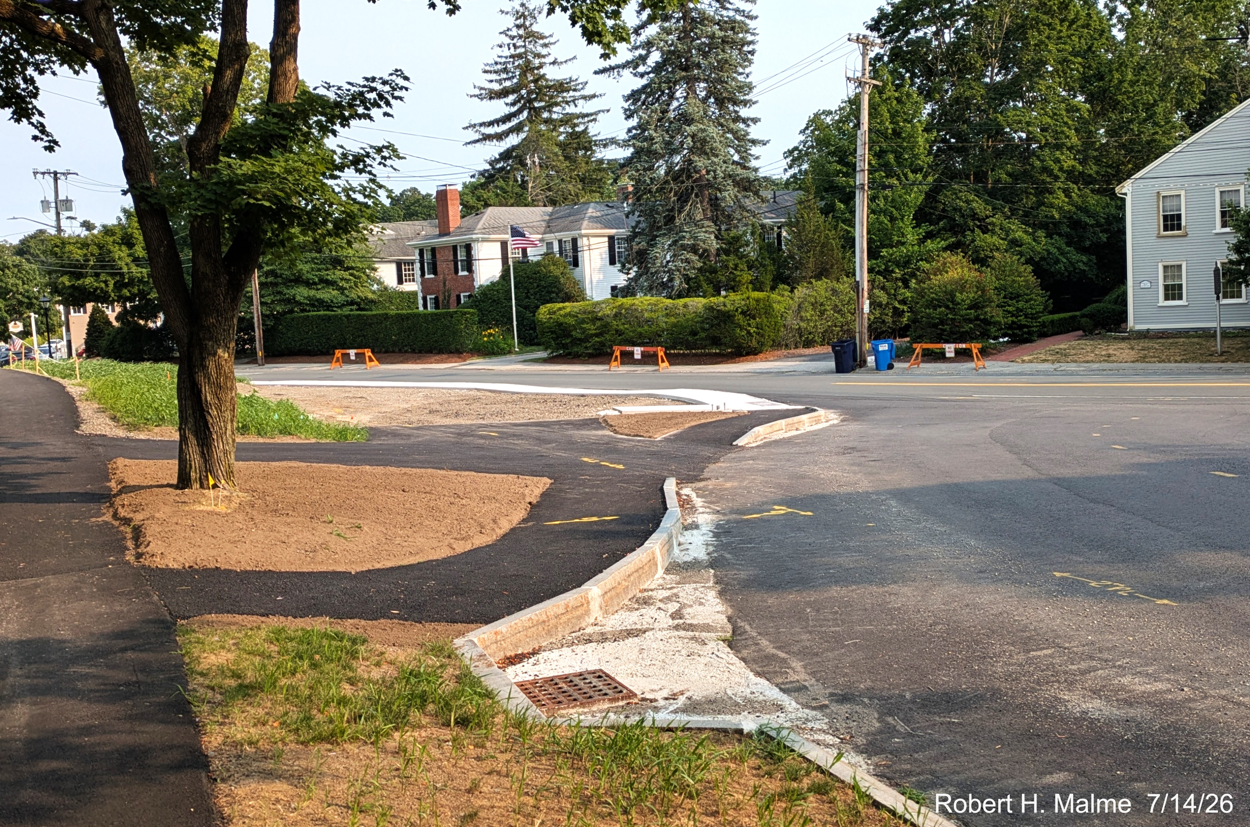 Image taken looking completed paving of sidewalk along Lincoln Street to the completed 
	concrete sidewalk along North Street, July 2026