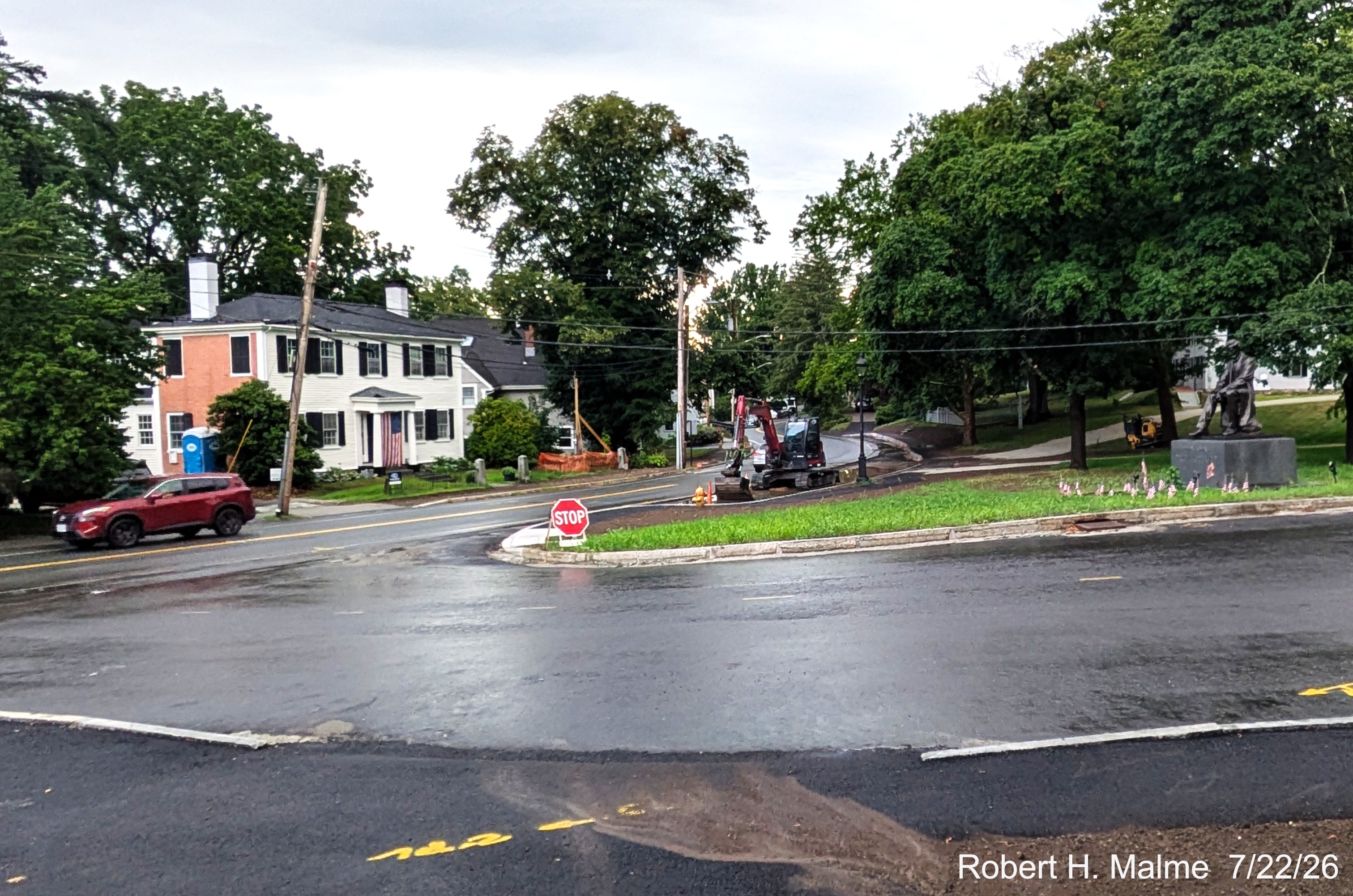 Image taken looking west at the Lincoln Street intersection with North Street showing
	temporary stop sign still in place while rain storm filled site of future parking spaces, July 2026