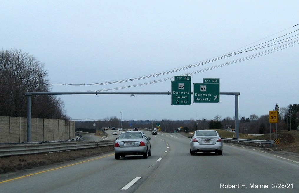 Image of overhead signage at ramp for MA 62 exit with new milepost based exit number on MA 128 South in Beverly, February 2021