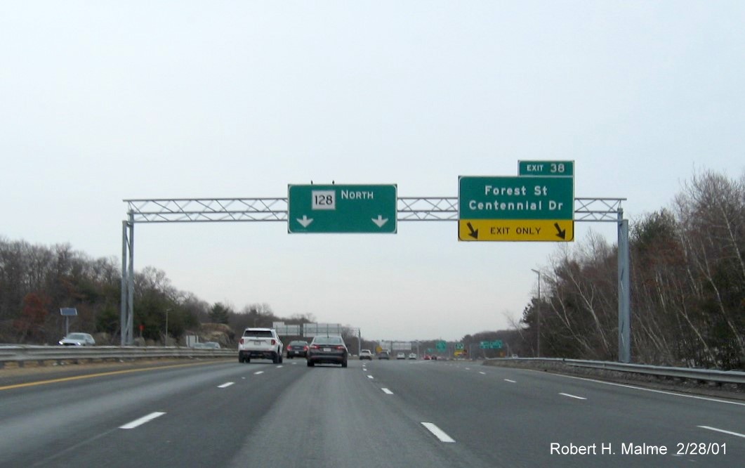 Image of overhead exit sign for Forest Street/Centennial Drive exit with new milepost based exit number on MA 128 North in Peabody, February 2021