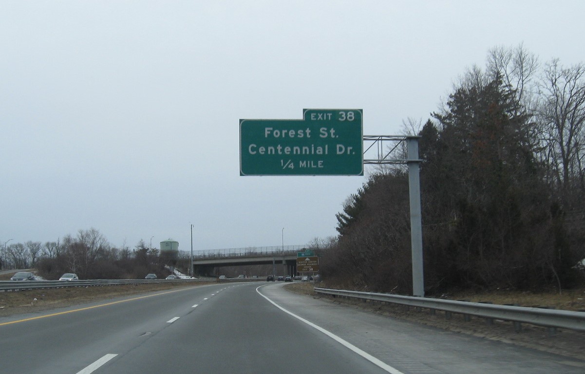 Image of 1/4 Mile advance overhead sign for Forest Street/Centennial Drive exit with new milepost based exit number on MA 128 South in Peabody, February 2021
