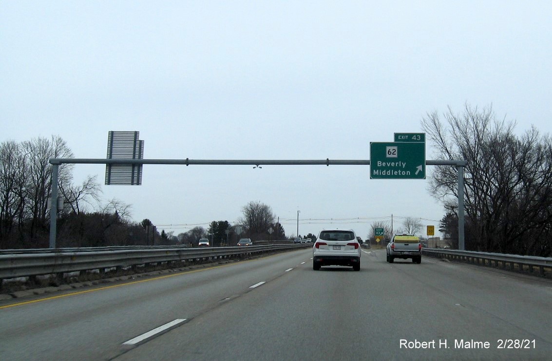 Image of overhead ramp sign for MA 62 exit with new milepost based exit number on MA 128 North in Beverly, February 2021