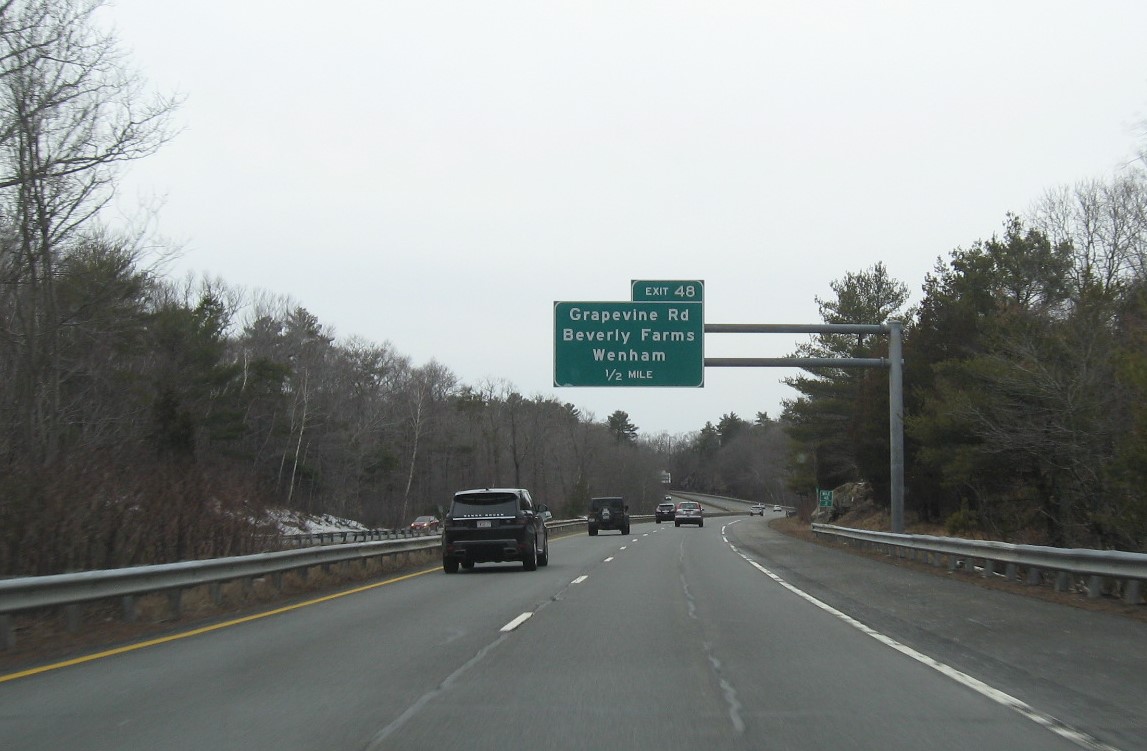 Image of 1/2 mile advance overhead sign for Grapevine Road exit with new milepost based exit number on MA 128 South in Wenham, February 2021