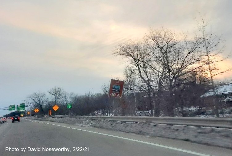 Image of small Essex County Scenic Byway sign with new huge milepost based exit number for the MA 114 exit on MA 128 North in Peabody, photo by David Noseworthy, February 2021