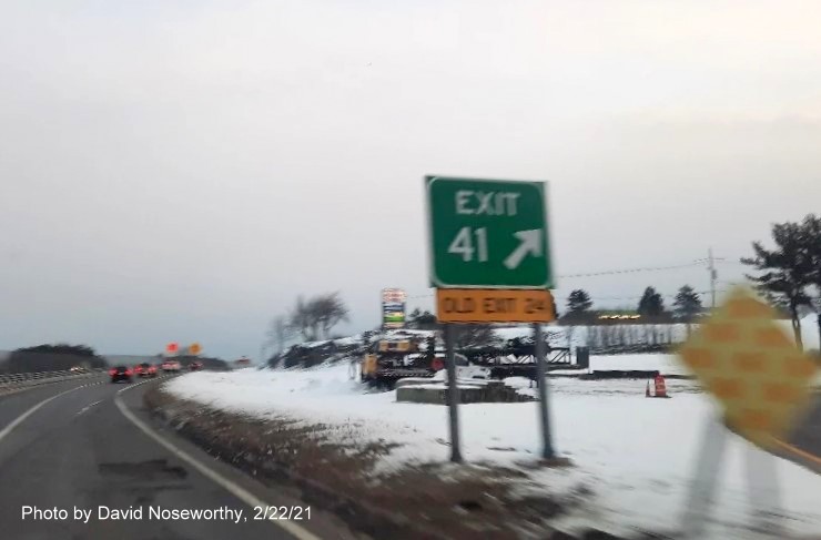 Image of gore sign for the Endicott Street exit with new milepost 
      based exit number and yellow old exit sign on the right support post on MA 128 North in Danvers, photo by David Noseworthy, February 2021