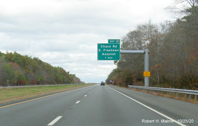Image of 1-mile advance sign with new milepost based exit number and yellow old exit number tab on support post on MA 140 North in Freetown, October 2020