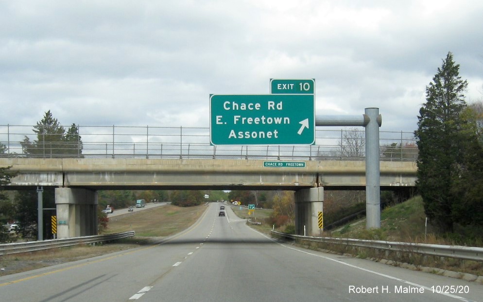 Image of overhead exit sign and gore sign for Chace Road exit with new milepost based exit number and yellow old exit number tab below gore sign on MA 140 North in Freetown, October 2020