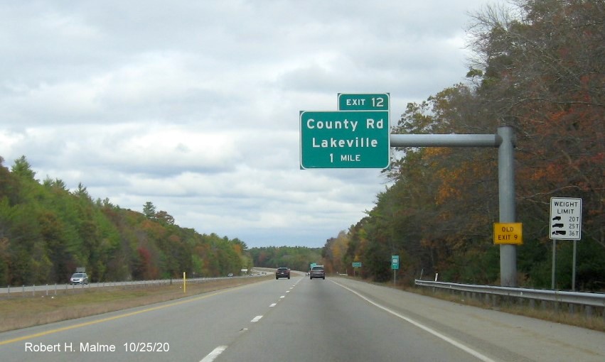 Image of 1-Mile advance overhead sign for County Road exit with new milepost based exit number and yellow old exit number tab on support post on MA 140 North in Lakeville, October 2020