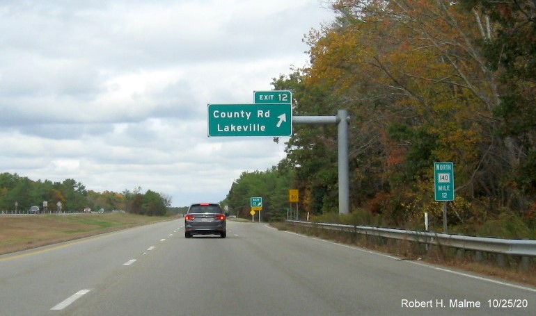Image of overhead ramp sign and gore sign for County Road exit with new milepost based exit numbers and yellow old exit tab below gore sign on MA 140 North in Lakeville, October 2020