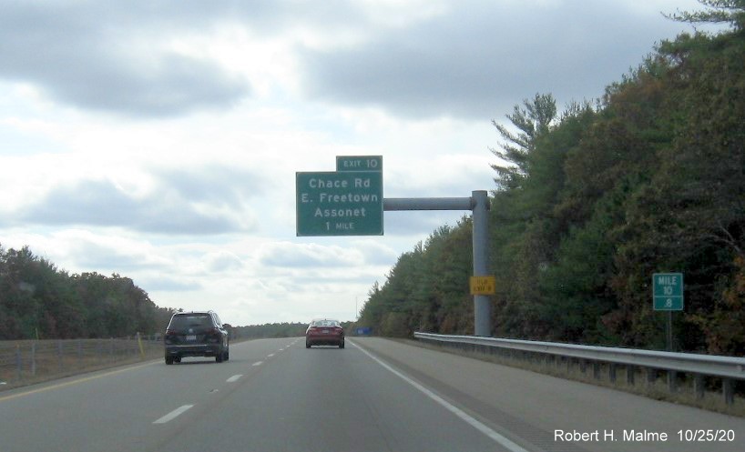 Image of 1mile advance overhead sign for Chace Road exit now with new milepost based exit number and yellow old exit number tab on support post on MA 140 South in Freetown, October 2020