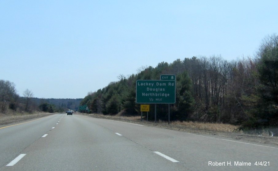 Image of 1/2 mile advance sign for Lackey Dam Road exit with new milepost based exit number and yellow Old Exit 4 advisory sign on left support on MA 146 South in Douglas, April 2021