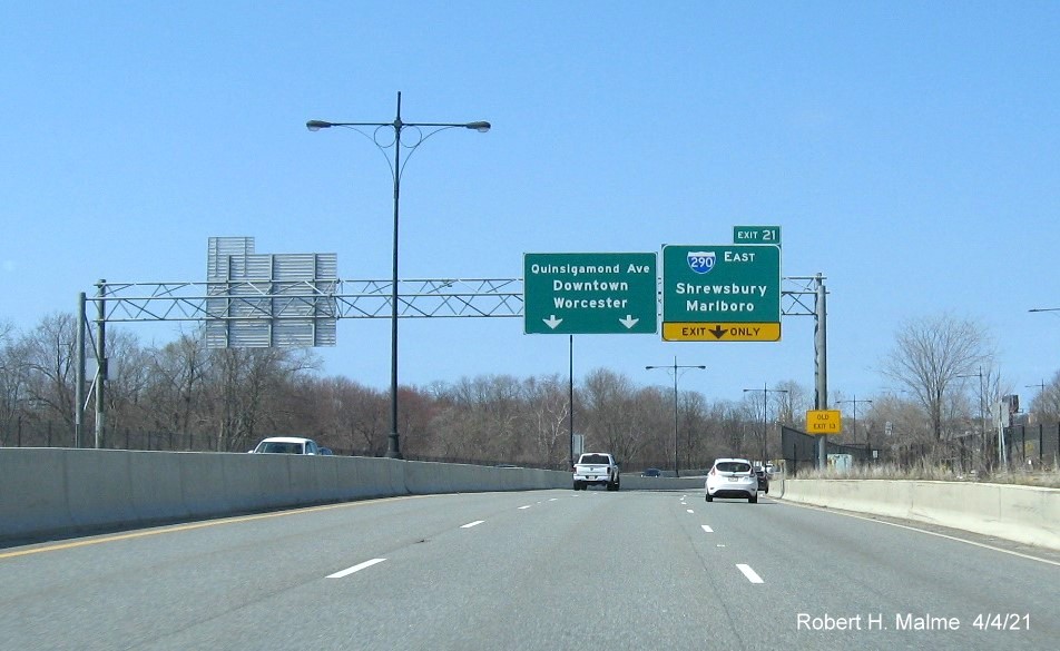 Image of overhead advance sign for I-290 East exit with new milepost based exit number and yellow Old Exit 13 advisory sign on right support on MA 146 North in Worcester, April 2021