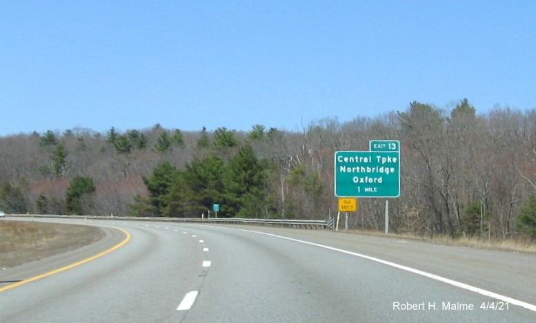 Image of 1 Mile advance sign for Central Turnpike exit with new milepost based exit number and yellow Old Exit 7 sign on left support on MA 146 North in Northbridge, April 2021