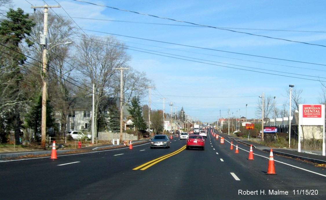 Image of freshly paved MA 18 4-lane roadway, restricted by traffic barrels, in South Weymouth prior to MA 58 intersection, November 2020