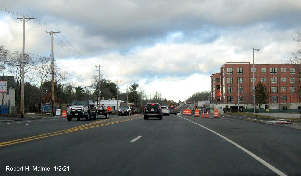 Image of widened 4-lane MA 18 northbound in South Weymouth approaching the lane closure at incomplete commuter
                                      railroad bridge, January 2021