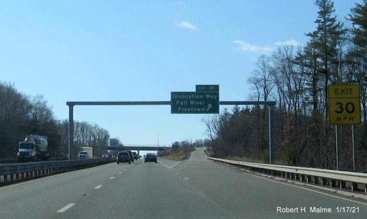 Image of overhead ramp sign for Innovation Way exit with new milepost based exit number and gore sign with new number and yellow Old Exit 8B sign below on MA 24 South in Freetown, January 2021
