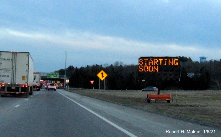 Image of VMS sign along right shoulder approaching the Harrison Blvd. exit alerting traffic to the exit
                                      renumbering project on MA 24 South in Avon, January 2021