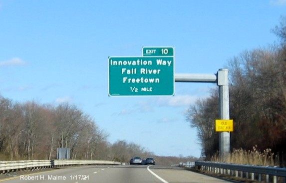 Image of 1/2 mile advance overhead sign for Innovation Way exit with new milepost based exit number and yellow Old Exit 8B sign on support post on MA 24 North in Freetown, January 2021