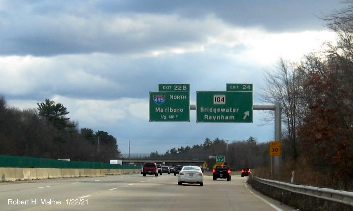 Image of overhead signage at ramp for MA 104 exit with new milepost based exit number and gore sign with new number and yellow Old Exit 15 sign below on MA 24 South in Bridgewater, January 2021